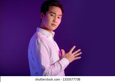 Portrait Of A Handsome Young Asian Business Man In White Shirt Looking At Camera With Confident Expression, Isolated Over Violet Or Puple Background. Human Faces And Images