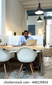 Portrait Of Handsome Young Black Man Working With Laptop At Home.