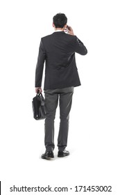 Portrait Of A Handsome Young Business Man Walking Carrying A Suitcase Back Ã¢Â?Â?full Body