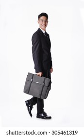 Portrait Of A Handsome Young Business Man Walking Carrying A Suitcase  Full Body