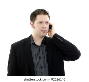Portrait of a handsome young business man talking on mobile phone. Isolated on white background with copy space.