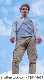 Portrait Of A Handsome Young Male In His Late Teens, Early 20s; Outdoors, Posing, Healthy Looking, Shot From Below, Different Angle
