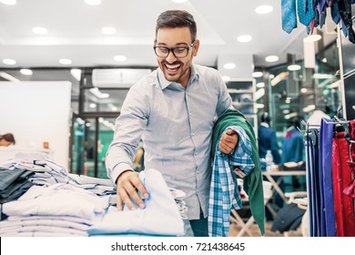 Portrait Of Handsome Young Man Buying Clothes In The Store.