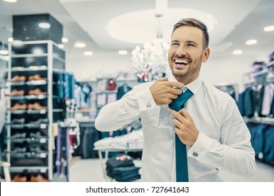 Portrait Of Handsome Young Man Buying Clothes In The Store.