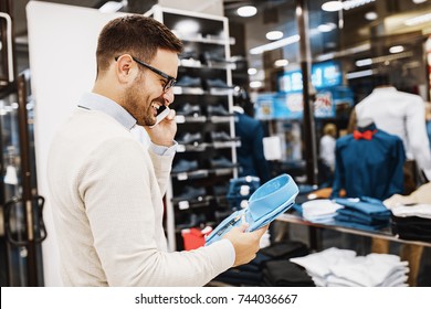 Portrait Of Handsome Young Man Buying Clothes In The Store.