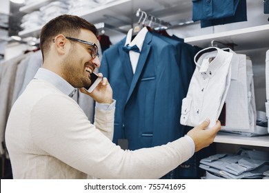 Portrait Of Handsome Young Man Buying Clothes In The Store.