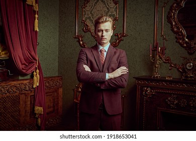 A Portrait Of A Handsome Young Man In A Formal Suit Posing In A Luxury Apartments With Classic Interior. Classic Fashion For Men.