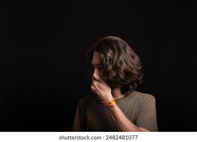 Portrait of handsome young man with long hair and brown eyes posing for photo isolated on black background. - Powered by Shutterstock