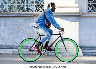 Portrait Of Handsome Young Man Riding Bike In The Street.