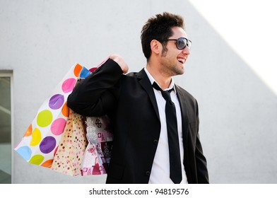 Portrait Of A Handsome Young Man With Shopping Bags