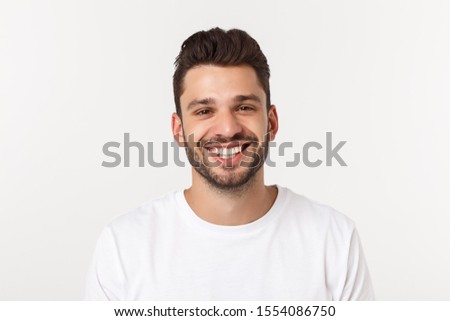 Portrait of a handsome young man smiling against yellow background