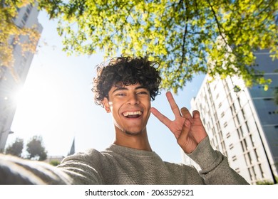 Portrait handsome young man taking selfie with hand peace sign