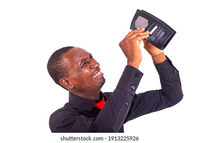 portrait of a handsome young man upset holding an empty wallet.