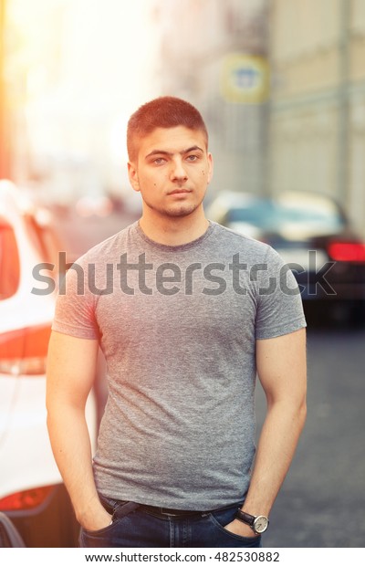 Portrait\
of handsome young muscular man in urban\
context