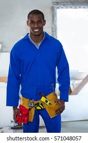 Portrait Of Handy Man Wearing Tool Belt At Home