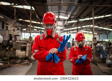 Portrait happiness industry workers with safety uniform ,blue glove and helmet to safety before start work to check chemical or gas in factory is industry safety concept. - Powered by Shutterstock