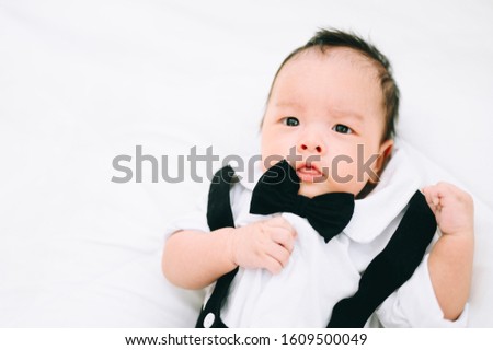 Portrait happy 2 months baby,Little boy in a white shirt and bow tie,Stylish boy in fashionable a bow tie tuxedo.