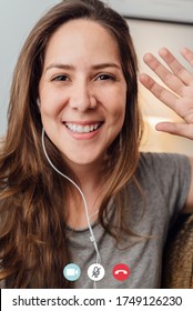 Portrait Of Happy 30s Aged Beautiful Girl Making Video Calling With Smartphone At Home. Waving On Phone Screen. Using Conferencing Meeting Online App