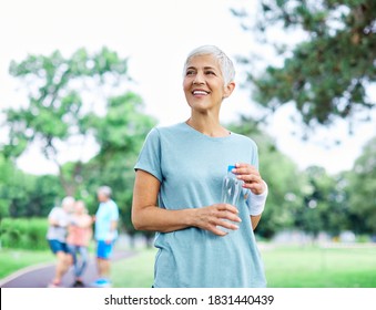 Portrait Of A Happy Active Beautiful Senior Woman Posing After Exercicing Outdoors