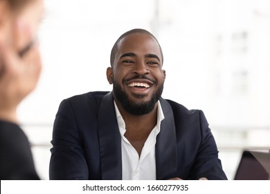 Portrait Happy African American Businessman Laughing At Meeting. Smiling Black Male Employee Having Business Conversation With Partners, Close Up Headshot Man Worker At Workplace In Office.