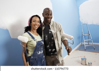 Portrait Of Happy African American Couple Painting Their New House