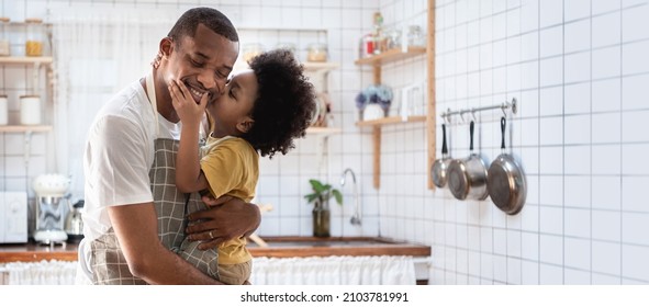 Portrait Of Happy African American Father And His Son While Cooking At Kitchen, Loving Black Little Boy Embracing And Kiss His Dad, Banner, Panoramic