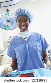 Portrait Of Happy African American Female Surgeon In Protective Work Wear Standing In Operating Room