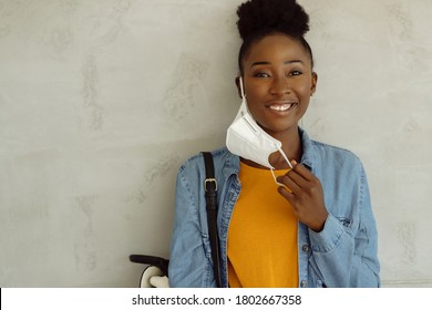 Portrait Of Happy African American Female Student Taking Off Protective Face Mask And Looking At Camera. Copy Space. 