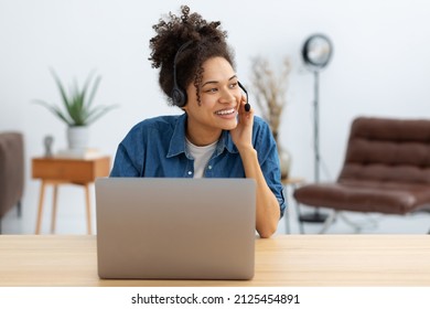 Portrait of happy African American female employee customer support services in headset, online consultation. Woman call center. Female customer support or sales agen