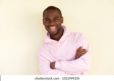 Portrait of happy african american man in hoodie posing with arms crossed