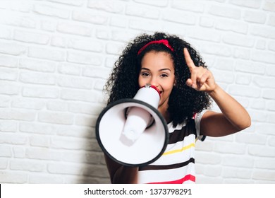 Portrait Of Happy African American Woman Shouting With Megaphone For Promotion, Advertising. Black Girl Smiling And Laughing For Fun, Joy, Happiness