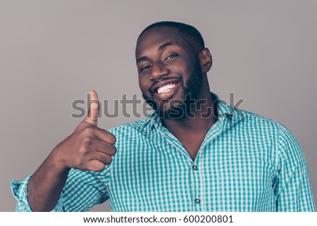 Portrait of happy afroamerican handsome bearded  man laughing and showing thumb up gesture
