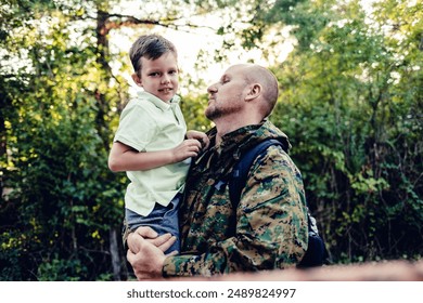 Portrait of happy american family. Happy american family, father with son. Happy male soldier dad reunited with son. Cheerful little boy is reunited with army soldier father. - Powered by Shutterstock