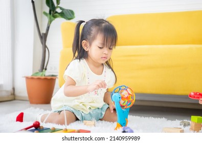 Portrait Of Happy Asian Child Playing In Living Room, Close Up Of Little Kid Girl Play With Toy