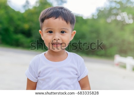 Portrait of happy Asian child toddler boy smiling close up looking at camera. Education Concept.