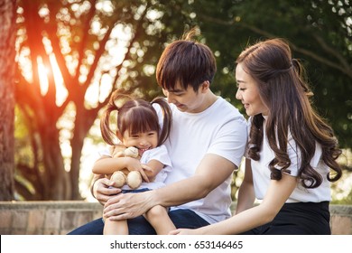 Portrait Of Happy Asian Family In Garden