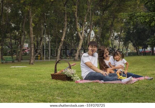 Portrait Of Happy Asian Family In\
Garden ,Beautiful family portrait ,Happy Asian Family In\
Garden