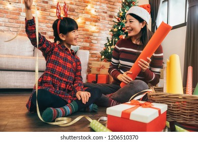 Portrait Of Happy Asian Family Little Girl Help Her Mother Wrapping Gift Box, Celebration Holiday Christmas. Young Mom And Girl Are Doing Handcraft Activity Enjoying Wrap Gifts.