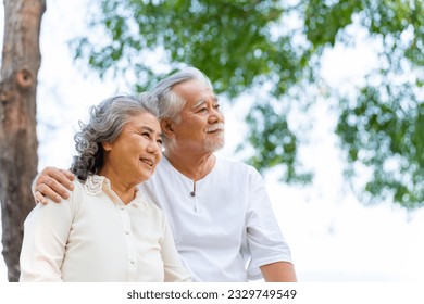 Portrait of Happy Asian family senior couple with gray hair resting together at tropical beach at summer sunset. Retired elderly people enjoy outdoor lifestyle travel nature ocean on holiday vacation. - Powered by Shutterstock