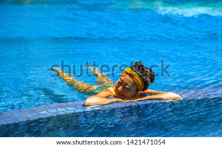 Portrait of happy asian girl in pool.