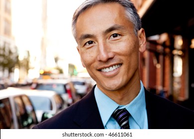 A Portrait Of A Happy Asian Looking Business Man