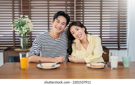 Portrait Of Happy Asian Loving Couple Enjoy Eating Breakfast In A Cafe Hotel Or Dining Table. Modern Family Love Dating Healthy Food Lifestyle Holiday Concept