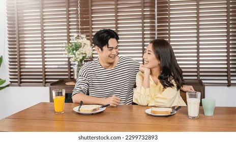 Portrait of happy asian loving couple enjoy eating breakfast in a cafe hotel or dining table. Modern family love dating healthy food lifestyle holiday, just married honeymoon period concept - Powered by Shutterstock
