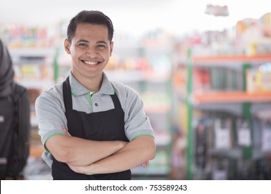 portrait of happy asian male shopkeeper