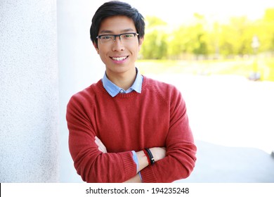 Portrait Of Happy Asian Man With Arms Folded