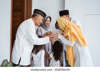 portrait of happy asian muslim family visiting grandparents on ramadan kareem. indonesian people celebrating eid mubarak - Powered by Shutterstock