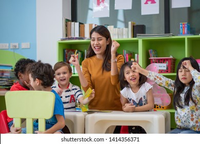 Portrait of happy Asian teacher teaching mix race kids in international school . mix race, education, international school, classroom, school activity, lifestyle or classroom learning concept