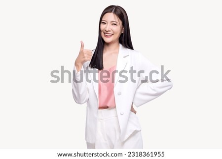 Portrait happy Asian woman shows thumb up and looking at the camera on white background.