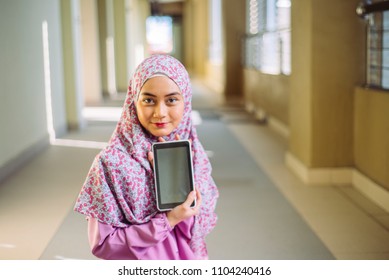 portrait of happy asian woman using mobile phone while sitting on a couch - Powered by Shutterstock