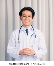 Portrait Of Happy Asian Young Doctor Handsome Man Smiling In Uniform With Stethoscope Talking Online Video Conference Call Or Facetime Looking To Camera, Healthcare Medicine Concept